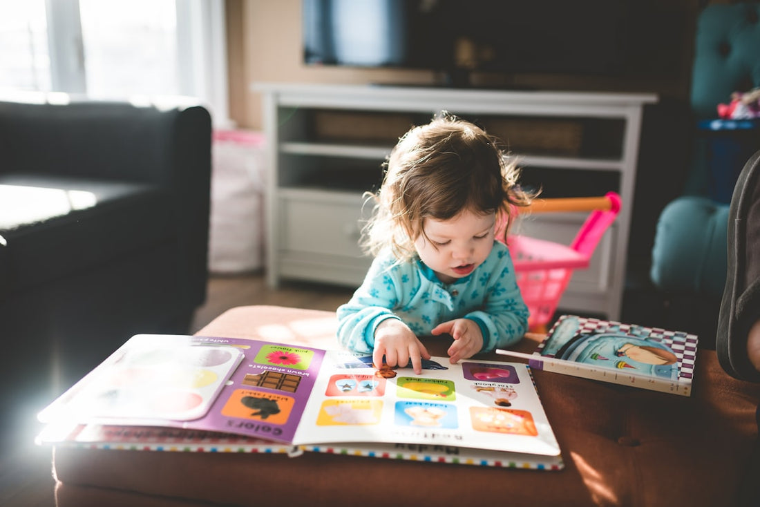 Child reading a book in backlit light
