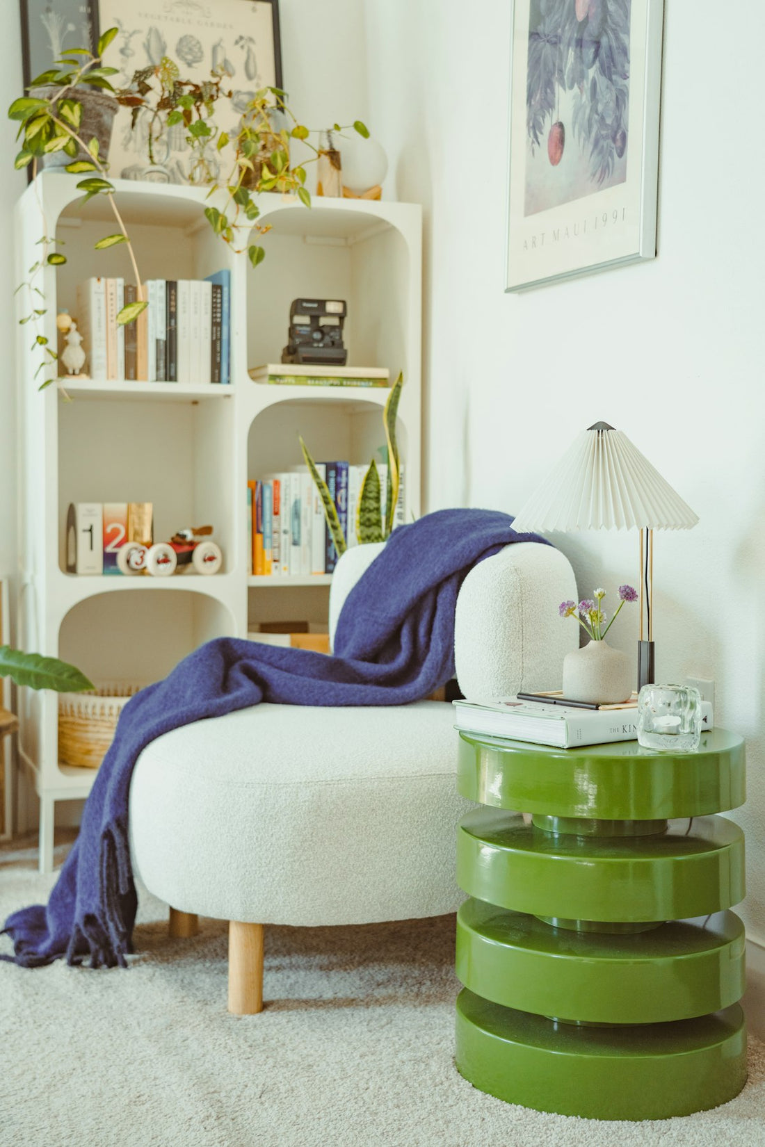 Cozy home reading nook with white chair and bookshelf